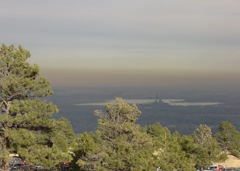 A picture of a thermal inversion over Boulder, Colorado, appears as a brown layer in the sky.